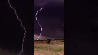 Absolutely gargantuan double lightning strike from a powerful supercell (wall cloud in the BG!!)