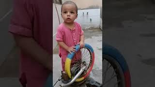 Muhammad Haziq with cycle wheel.