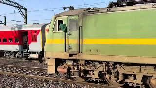 Twins WAP 7 locomotive powering 11019 Konark express crossing with freight train at Talegaon