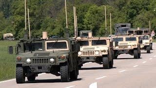 Over a hundred US Army trucks and artillery travel in convoys through Germany  