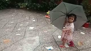 Heavy rain and Isra baby is enjoying under umbrella without fear