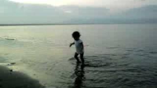 Baby playing on the Beach.mp4