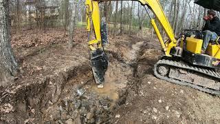 Hammering a drainage trench