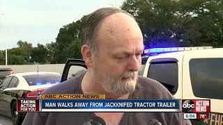 Man walks away from jackknifed tractor trailer