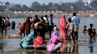 Devotees offer prayers after taking a holy bath in river Ganga