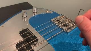 How to adjust string height on a bass guitar