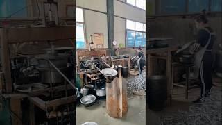 A glimpse into a metal bowl manufacturing process.