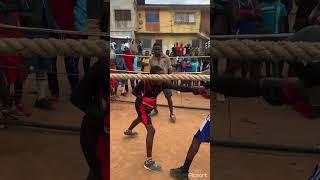 Ayomide Atanda intense sparring with a young fighter on the street of Lagos.