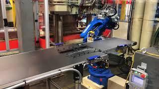 Chism Automation - Injection molding press tending with a 6 axis robot with a conveyor end of arm to