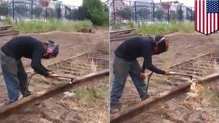 Man vs train tracks: Rail worker cutting through train tracks is about to experience pain - TomoNews