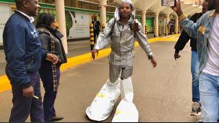 ERIC OMONDI CAUSES STANDSTILL AT THE AIRPORT WITH HIS GIANT DRAMATIC SHOES