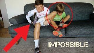 TRYING TO TAKE OFF FOOTBALL BOOTS AND SOCKS WITHOUT HANDS (FORFEIT)