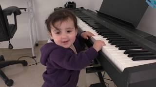 A baby playing piano