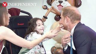 Prince Harry laughs as young boy pulls his beard at WellChild awards in London