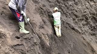 hard work..!!! the miners digging sand and rocks from a cliff