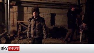 Ukrainian families shelter in basements from artillery fire