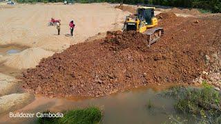 Professionals operator skills machines dozer shantui pushing Soil making new village road and tucks