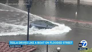 Tesla car plows through flooded San Diego street
