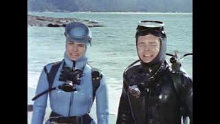 Female diver with vintage wetsuit and fancy gear