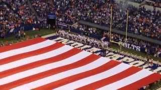 Bald eagle flies over a giant American flag before a Colts game