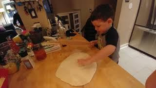 Tomlin helps roll pizza dough