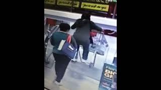 Lady tries to bring shopping cart down an escalator...