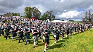 Drum Majors lead massed pipe bands salute to Chieftain opening 2024 Dufftown Highland Games Scotland