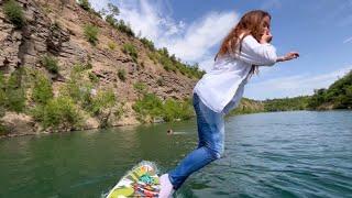 in jeans on a water board