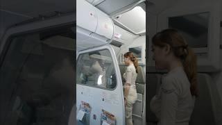 Junior flight attendant is watching the process of closing the airbus 320 door ️