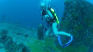 Woman Scuba Diver Exploring Underwater Wreck