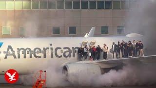 American Airlines plane bursts into flames as passengers escape on wing