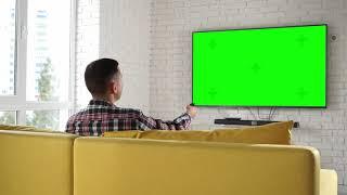 Man Watches Tv Set Green Screen | Free Video Stock Footage | Creator Stockify