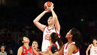 China's 7-foot-3 teen basketball star towers over her competitors in viral video