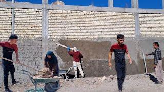 Making concrete by Abbas and his father to help the workers in the wall construction