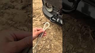 The process of tying a rope knot when towing a car