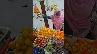 Hijab girl buying orange 