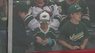 Emotional young boy finally receives souvenir after girl gifts pucks