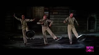 Gene Kelly, Michael Kidd & Dan Dailey dance their famous trash can lid routine.