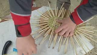 fragment of weaving an oval bottom made of willow twigs