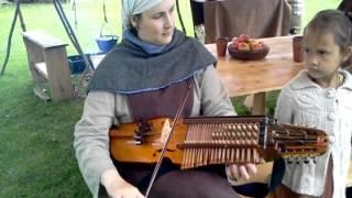 Nyckelharpa played by medieval girl Schlüsselfiedel Schlüsselgeige Keyed Fiddle