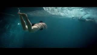Asian Woman doing Dolphin Swim Underwater