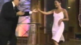 Jennifer Lopez in white dancing with Jay Leno