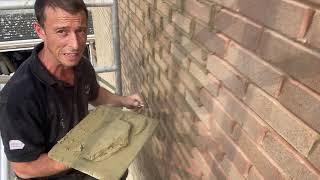 REPOINTING BRICKWORK using a hawk and trowel.