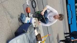 Guy makes music on main square in Zagreb using pans and accesories