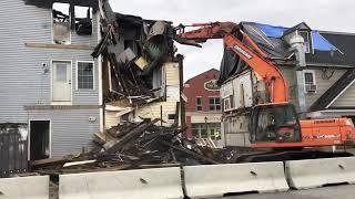 Time lapse of fire-damaged buildings getting demolished