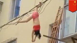 Defying Death: Woman dangles from power line - TomoNews