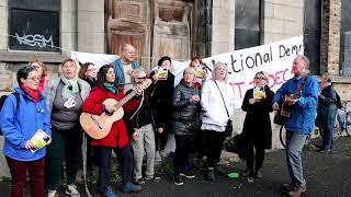 The National Homeless And Housing Coalition with The Resistance choir outside Player Wills Factory.