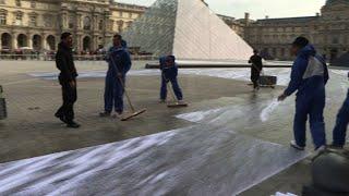 French artist JR surrounds Louvre Pyramid with giant collage