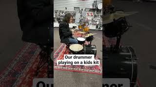 Playing a kids drum set