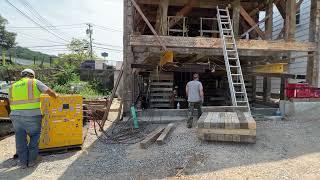 Lowering the Roslyn Grist Mill onto its new foundation